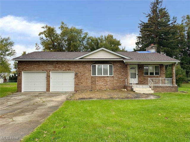 ranch-style house featuring a front lawn, a garage, and covered porch