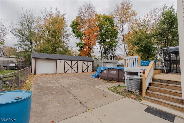 3594 W 49th St, Cleveland, OH 44102 - view of yard with fence, an outdoor structure, a garage, and a wooden deck