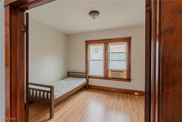 3594 W 49th St, Cleveland, OH 44102 - bedroom featuring baseboards, light wood-style floors, and cooling unit