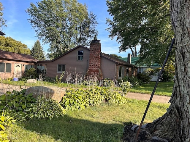 view of home's exterior with a yard