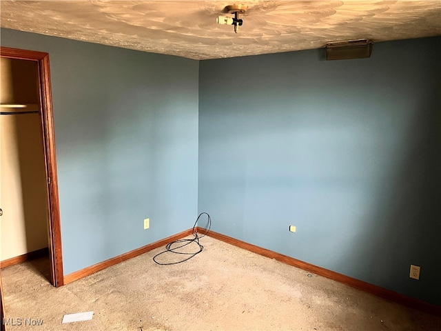 unfurnished bedroom with a closet and light carpet