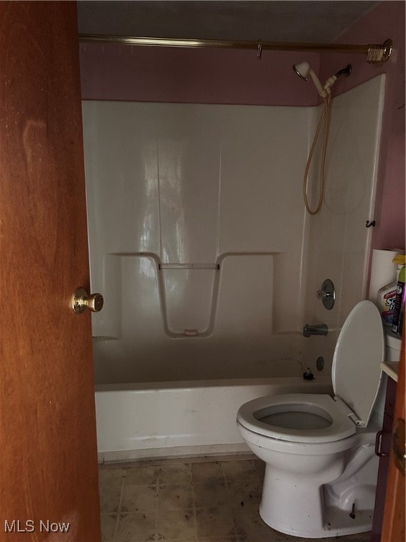 bathroom featuring washtub / shower combination and toilet