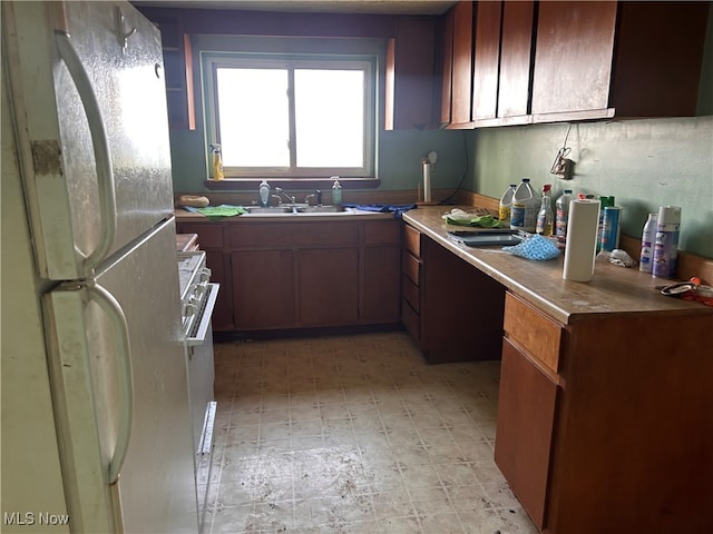 kitchen with sink and white fridge