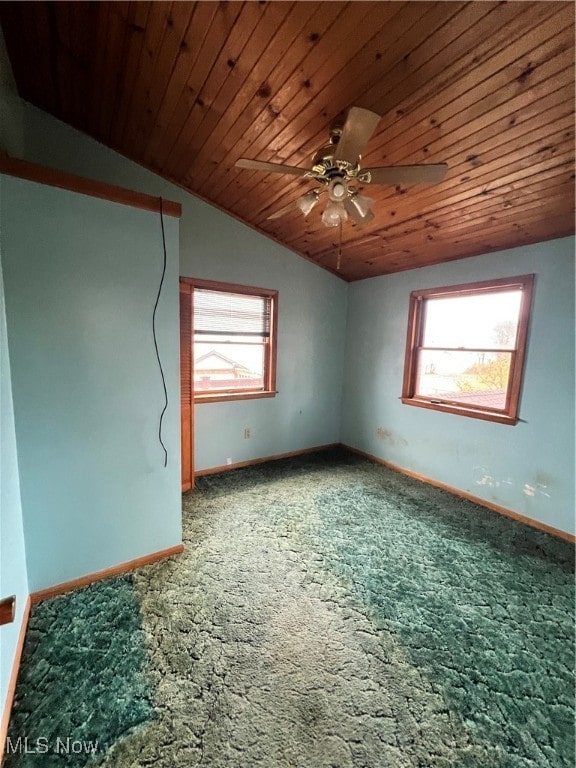 additional living space with lofted ceiling, wood ceiling, carpet flooring, and plenty of natural light