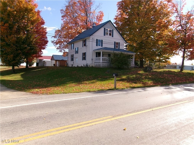 exterior space with a lawn and a porch