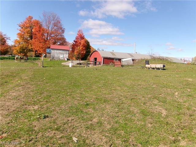 view of yard with a rural view and an outbuilding