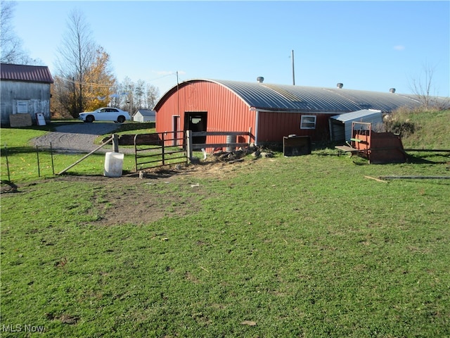 view of outbuilding with a yard