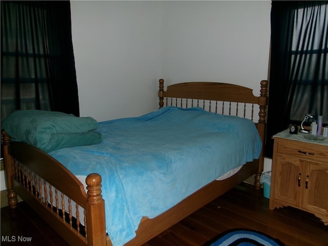 bedroom featuring dark hardwood / wood-style flooring