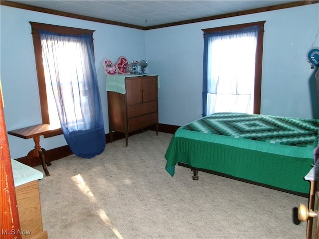 bedroom with carpet floors and crown molding