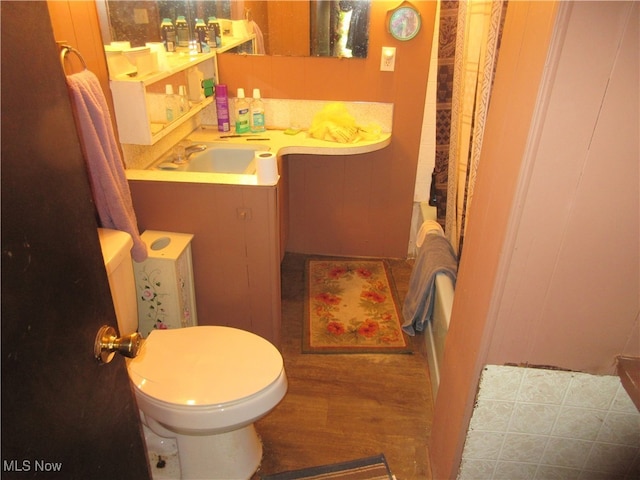 bathroom featuring hardwood / wood-style flooring, vanity, and toilet