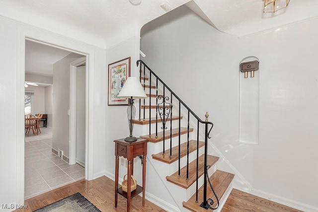 staircase featuring wood-type flooring