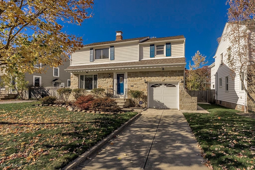 front of property with a front yard and a garage