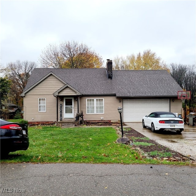 ranch-style house featuring a garage and a front lawn