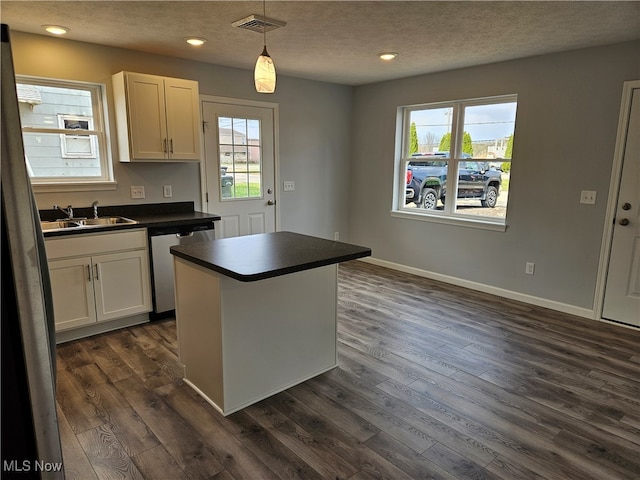 kitchen with stainless steel appliances, white cabinetry, and a wealth of natural light