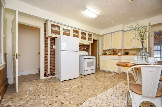 kitchen featuring white appliances and a textured ceiling