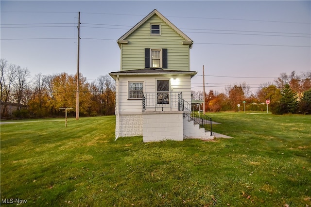 rear view of house with a yard