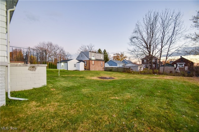 view of yard at dusk