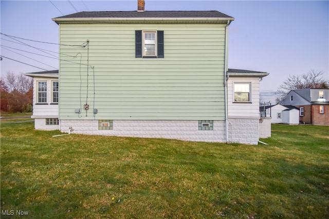 view of side of home with a lawn