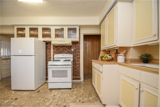 kitchen featuring white appliances, a textured ceiling, ventilation hood, and decorative backsplash