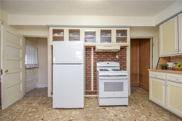 kitchen featuring a textured ceiling and white appliances