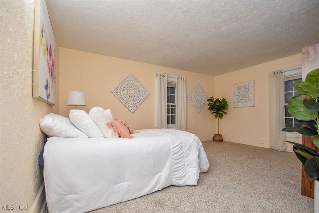 carpeted bedroom with a textured ceiling