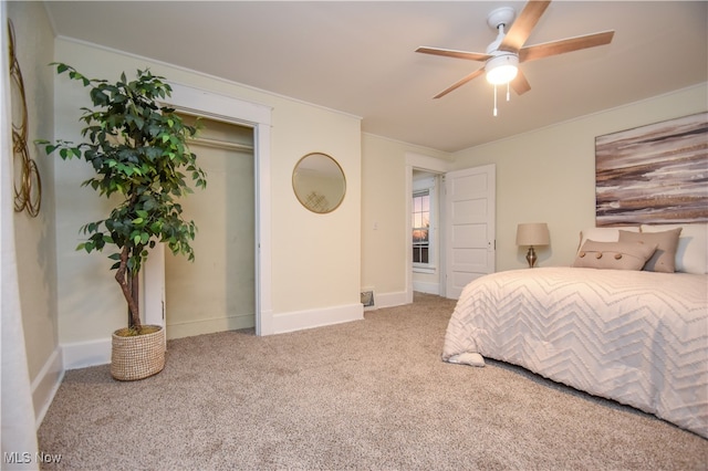 carpeted bedroom with ceiling fan and a closet