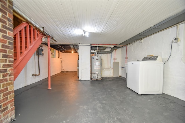 basement with water heater and washer / dryer