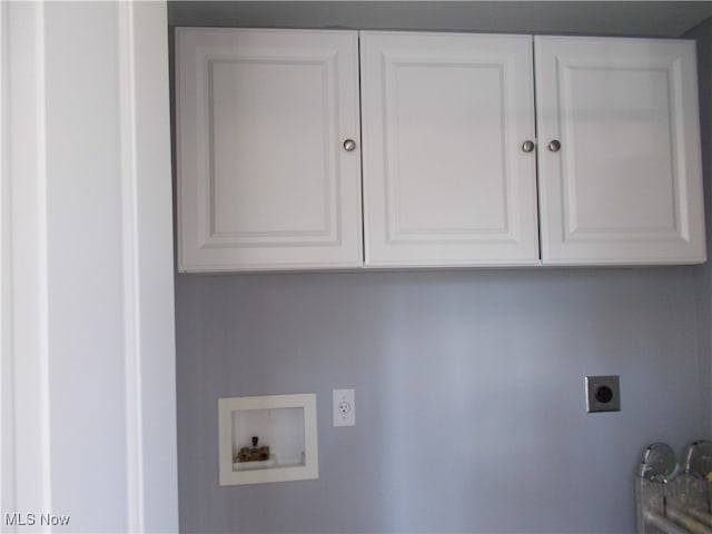 clothes washing area featuring cabinets, hookup for a washing machine, and electric dryer hookup