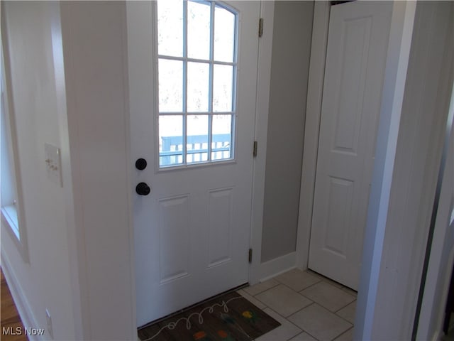 entryway with light tile patterned floors