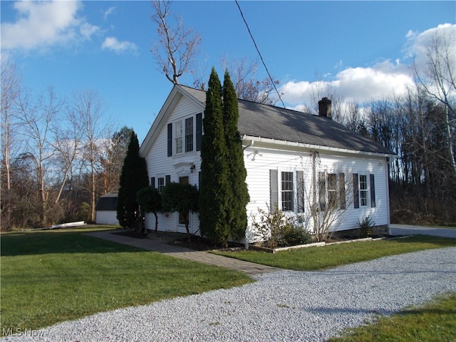 view of home's exterior featuring a lawn and a garage