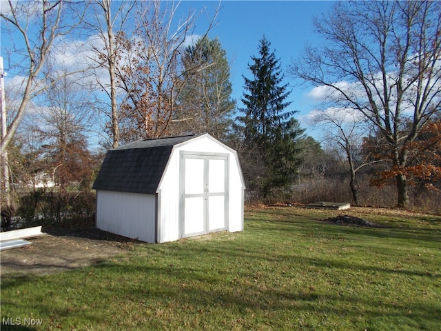 view of outdoor structure with a lawn