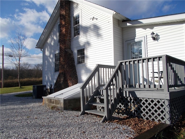 view of side of home featuring central air condition unit and a deck