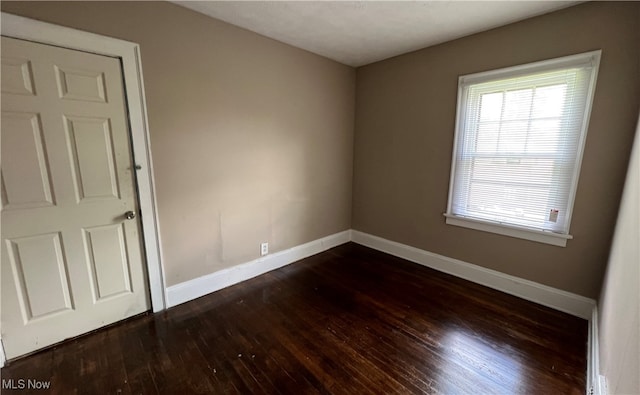 empty room featuring dark hardwood / wood-style flooring