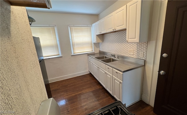 kitchen with white cabinets, decorative backsplash, dark wood-type flooring, and sink