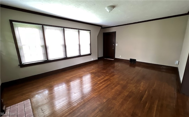 unfurnished room with dark wood-type flooring and crown molding