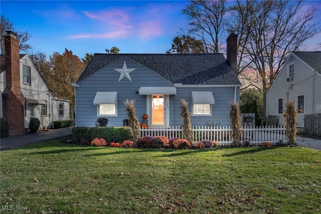 view of front of property with a lawn