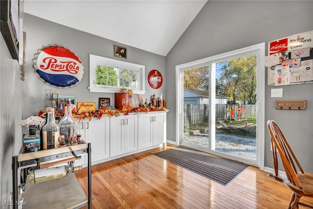 entryway featuring light hardwood / wood-style floors, vaulted ceiling, and a wealth of natural light