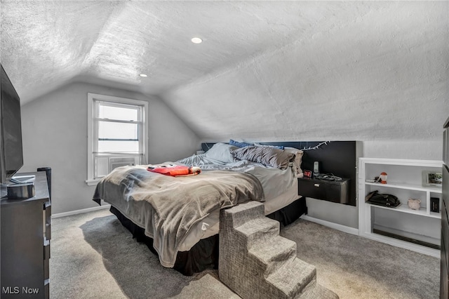 bedroom featuring carpet flooring, a textured ceiling, and vaulted ceiling