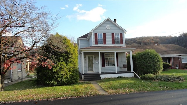 128 Columbia, Chester, WV 26034 - view of front of property featuring covered porch, a chimney, and a front lawn