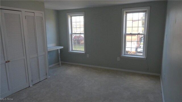 128 Columbia, Chester, WV 26034 - unfurnished bedroom with carpet, multiple windows, and baseboards
