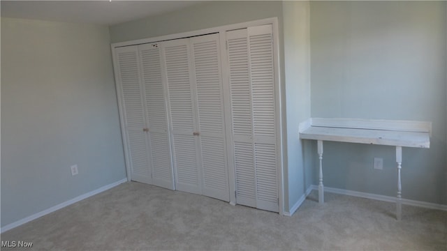 unfurnished bedroom featuring light carpet