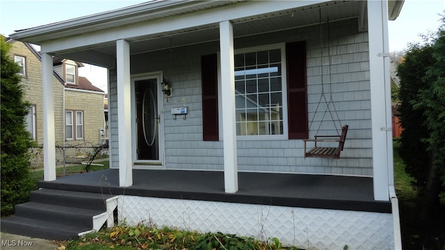 view of exterior entry featuring a porch