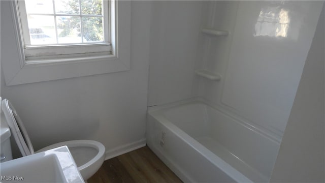 bathroom with hardwood / wood-style flooring and toilet