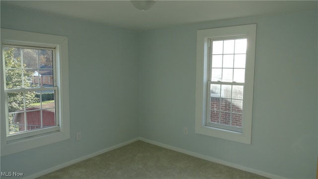 carpeted empty room featuring a healthy amount of sunlight