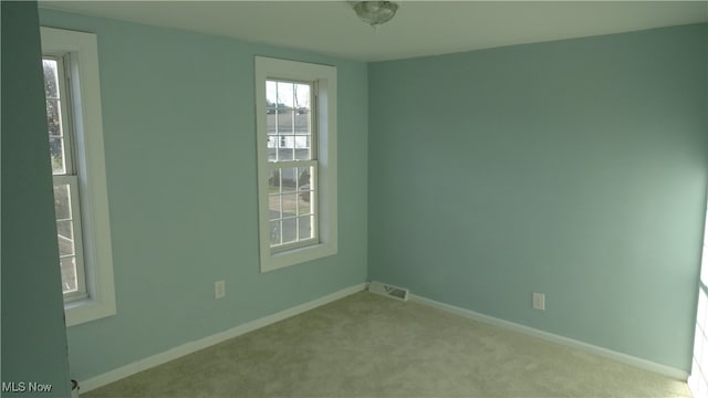 unfurnished room with light colored carpet