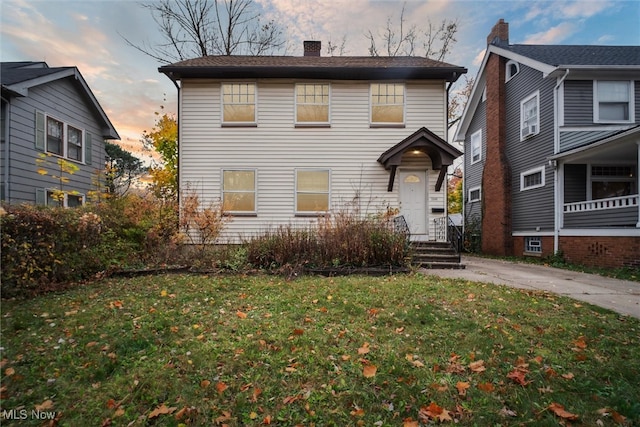 view of property featuring a lawn