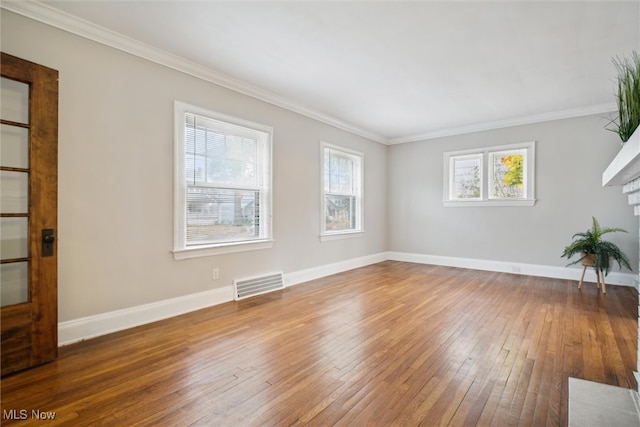 unfurnished room featuring hardwood / wood-style flooring and crown molding