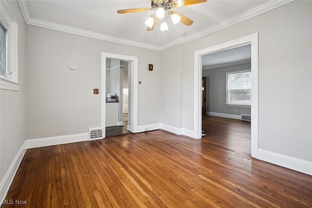 empty room featuring ceiling fan, crown molding, and dark hardwood / wood-style flooring