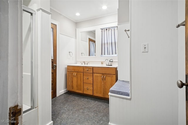 bathroom with shower / bath combination with glass door and vanity