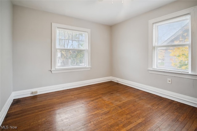 unfurnished room featuring dark hardwood / wood-style floors